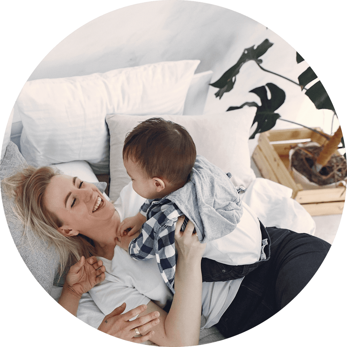 a woman lying on a bed with a baby